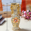 Gold-plated ceramic tabletop vase with ornate design and a central floral motif