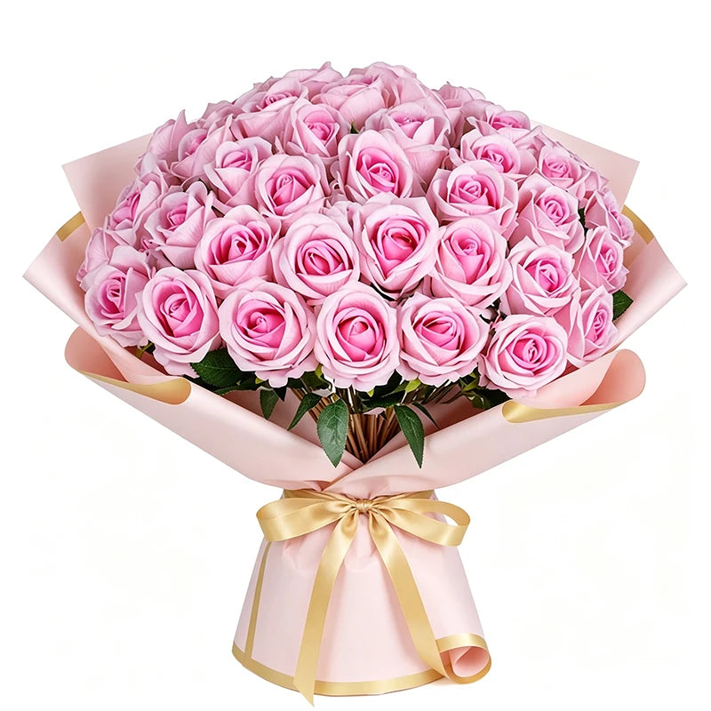 A bouquet of pink artificial roses in a light pink paper wrapping tied with a gold ribbon.