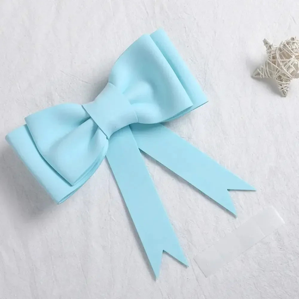 Topper en mousse bleu clair avec nœud décoratif et ruban satiné