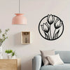 A set of three metal flower wall art pieces featuring tulips in black outline and a pink pendant light above them.