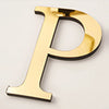 A gold acrylic mirror letter P wall sticker with a black border, shown in a slight angle.