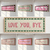 A collection of framed canvas prints featuring playful quotes like Kitchen Disco, Dramatic Exit, and Love You Bye in pink and