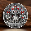 A commemorative coin featuring a silver-plated knight in armor surrounded by demons and text about fighting together.