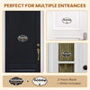 A set of two black and white wooden no soliciting signs for multiple entrances.
