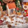 A collection of small deer figurines in various poses and sizes scattered across a snowy surface with a miniature house.