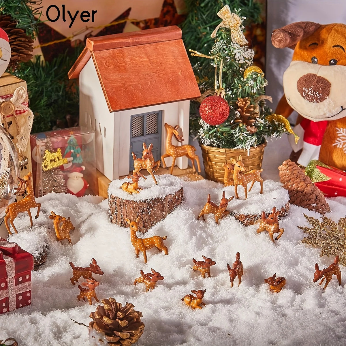 A collection of small deer figurines in various poses and sizes scattered across a snowy surface with a miniature house.