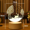 A white acrylic night light featuring a silhouette of a deer in a forest setting.