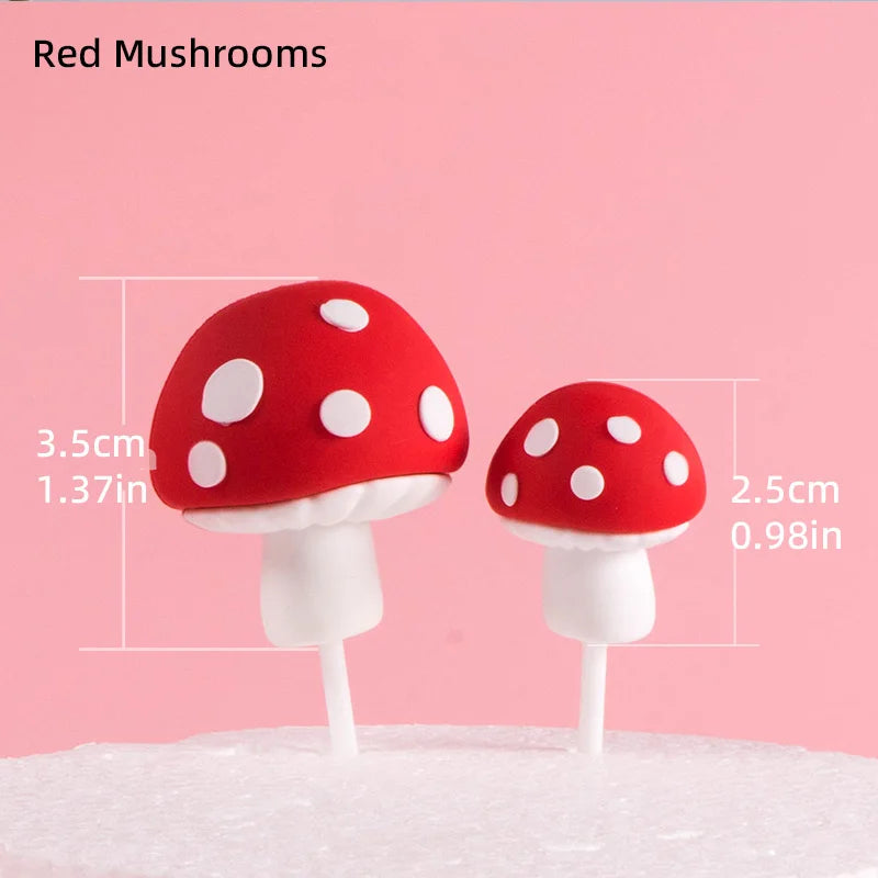 Two red mushroom cake toppers with white stems and white polka dots on a pink background.