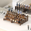 A display of various glass bottles and jars arranged on stacked wooden tiers for event or farmhouse decor.
