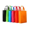 A collection of colorful kraft paper gift boxes with ribbon ties in various shades of green, blue, orange, and black.