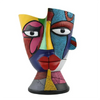 Abstract resin decorative planter pot featuring vibrant colors and facial features.