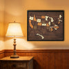 A framed wooden map of the USA showing states with stickers, displayed on a wall above a wooden cabinet.