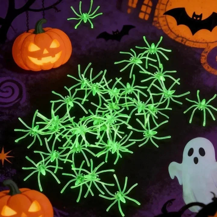 Glow-in-the-dark spider web Halloween decor featuring fake spiders and a carved pumpkin on a dark purple background.