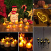 A set of glowing yellow and orange flameless LED tea light candles displayed on a wooden surface.