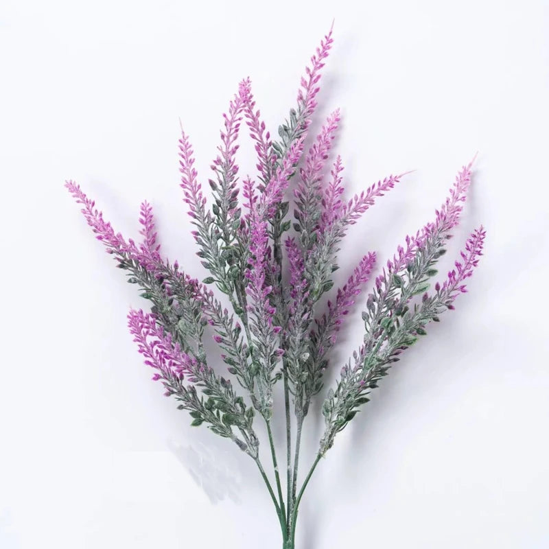 A sprig of purple lavender with delicate pink flowers and green foliage.