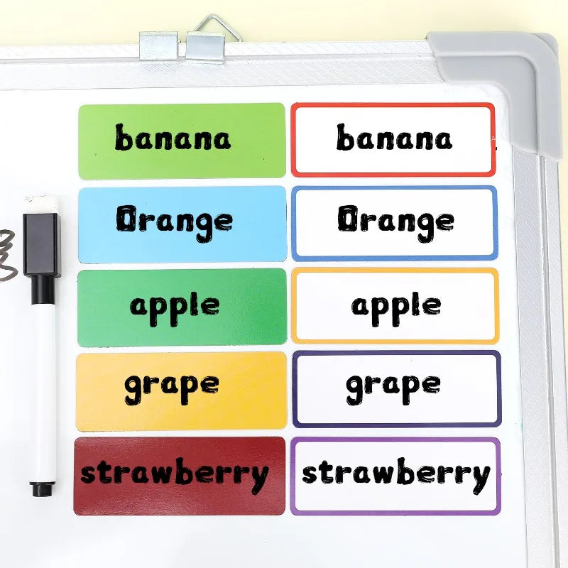 A set of reusable magnetic dry erase labels featuring various fruits like banana, orange, apple, grape, and strawberry.