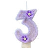 A purple sparkling number three candle decorated with small purple flowers.