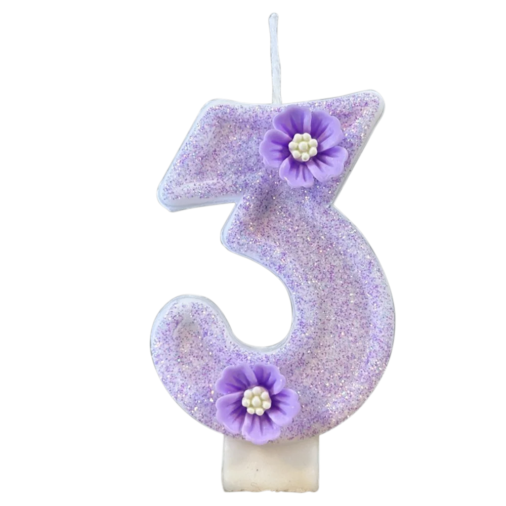 A purple sparkling number three candle decorated with small purple flowers.
