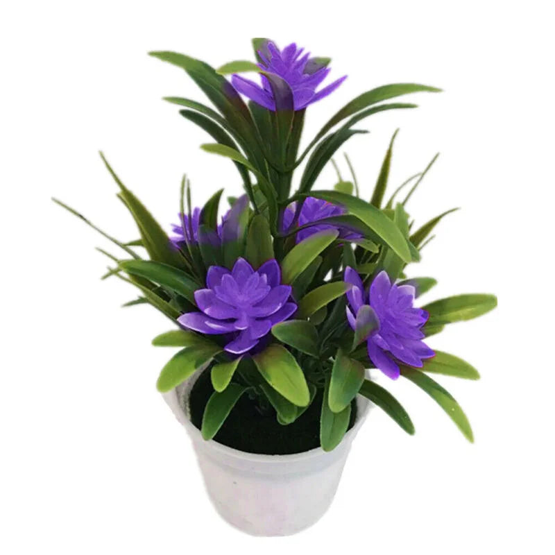 Artificial purple lotus flowers in green foliage planted in a white decorative pot