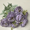 A bouquet of nine realistic purple silk roses with green leaves.