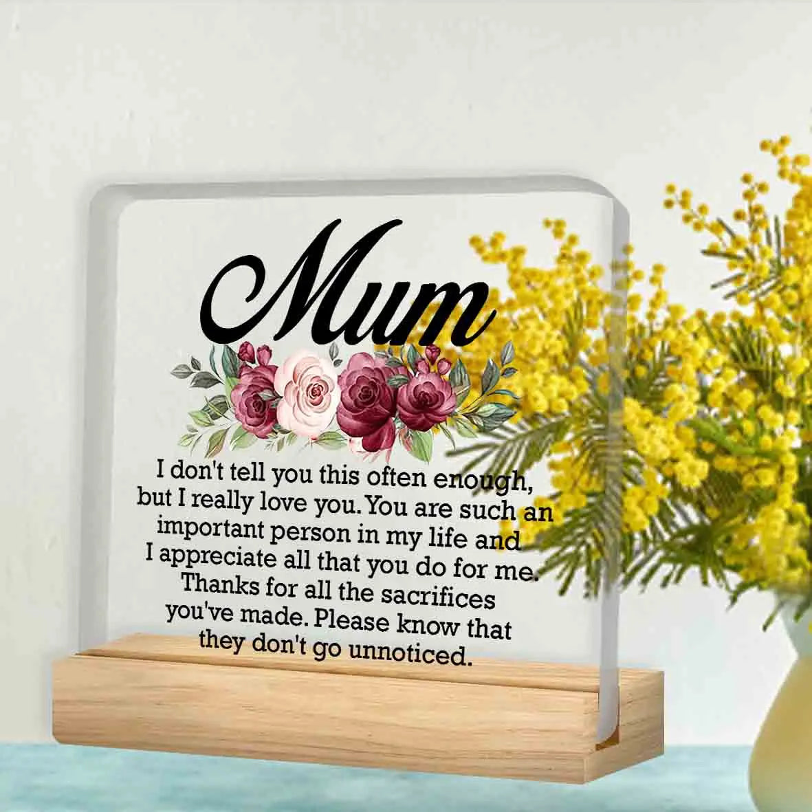 A personalized acrylic keepsake plaque with a wooden base featuring a floral design and a heartfelt message for Mom.