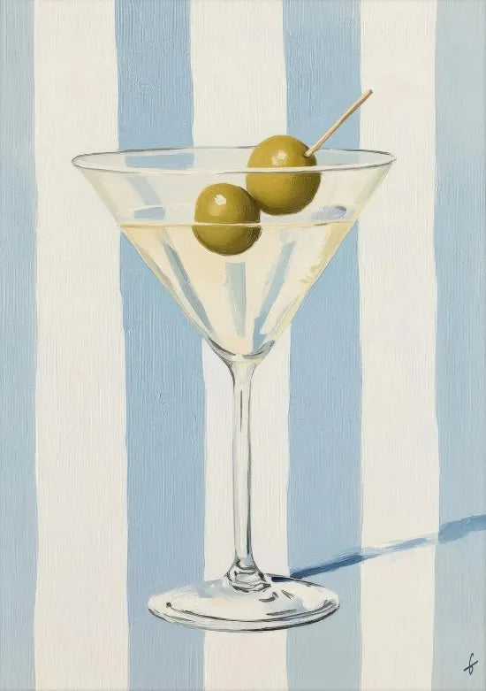 A glass of light yellow liquid with green olives and a wooden skewer, set against a background of vertical blue and white str