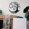 Black metal silhouette of a tree of life art mounted on a white wall above a rustic fireplace