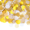 A pile of round tissue paper confetti dots in shades of gold and yellow.
