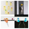 A collection of yellow and purple neodymium pin magnets with plastic shells displayed against a gray background.