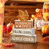 A set of rustic wooden maple leaf tiered trays for seasonal display on a wooden surface.