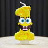A SpongeBob character shaped candle in the form of the number one, covered in yellow glitter.
