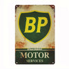 Vintage metal tin sign with a green shield featuring the letters BP and the text APPROVED MOTOR SERVICES
