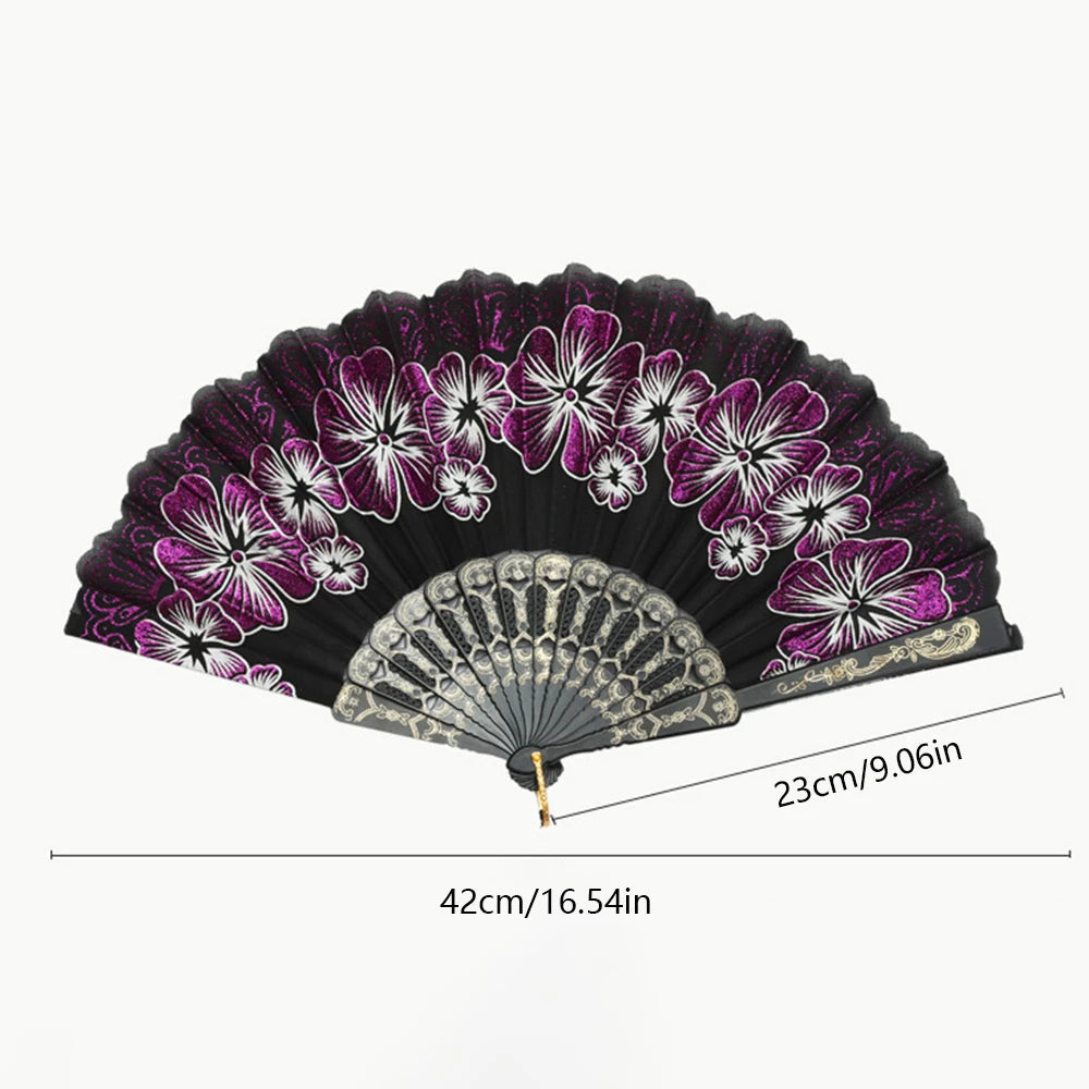 A black folding fan decorated with purple and white floral patterns.