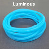 A set of ten luminous, translucent blue silicone bracelets coiled together.