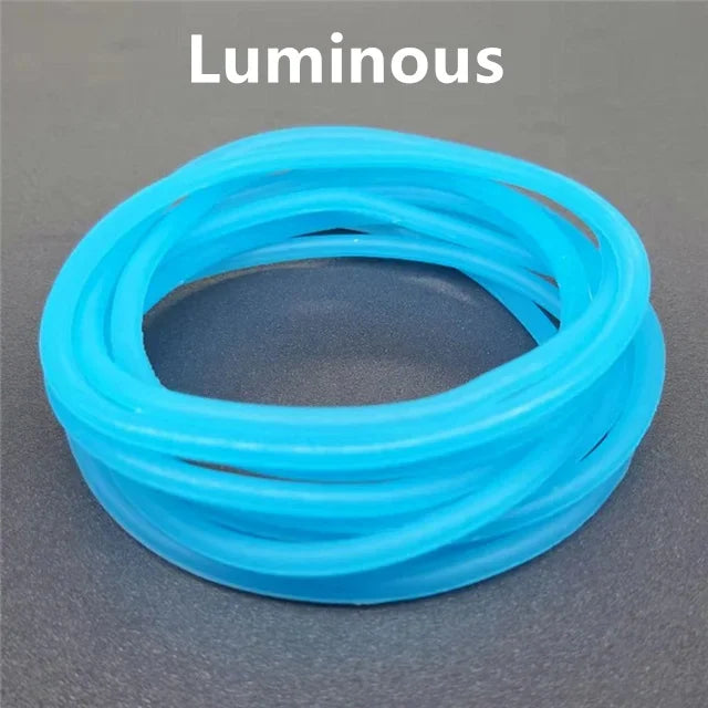A set of ten luminous, translucent blue silicone bracelets coiled together.