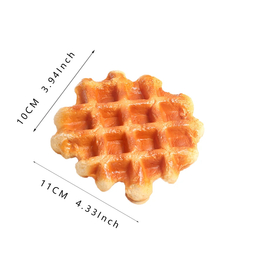 A golden brown waffle replica with a grid pattern, shown from above.
