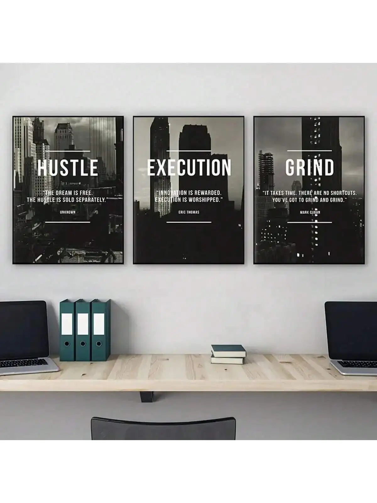 A set of three framed black and white motivational posters titled Hustle Execution and Grind displayed on a light gray wall a