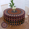 Bohemian peacock mandala round tablecloth with intricate patterns displayed on a wooden table.