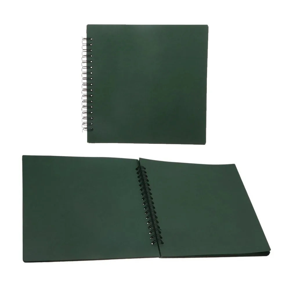 A closed dark green handmade kraft paper scrapbook with a spiral binding.