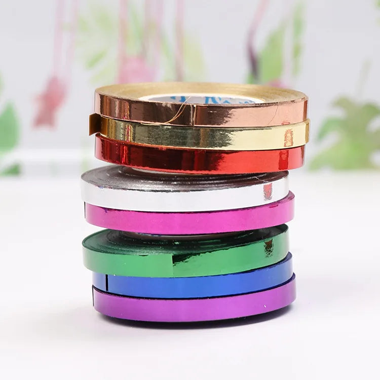A stack of colorful satin balloon ribbon rolls in various colors including red, pink, green, blue, and purple.