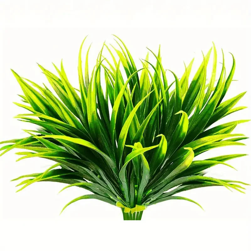 A vibrant green artificial tall grass and tropical flower arrangement for indoor or outdoor decor.