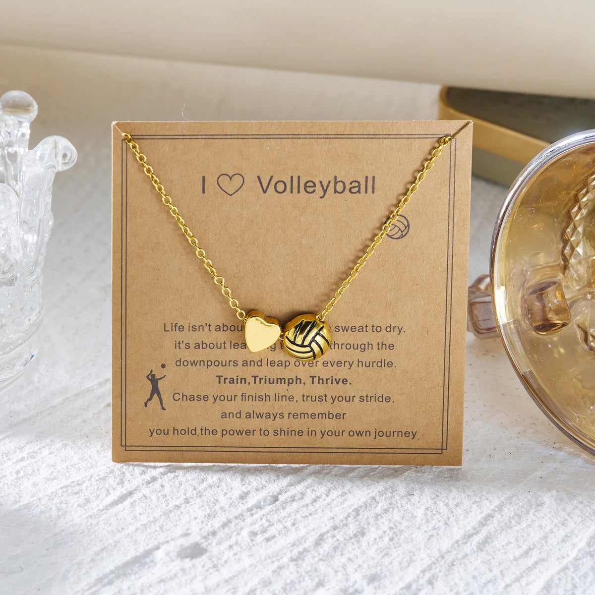 Gold heart basketball pendant necklace on a kraft paper card with inspirational text