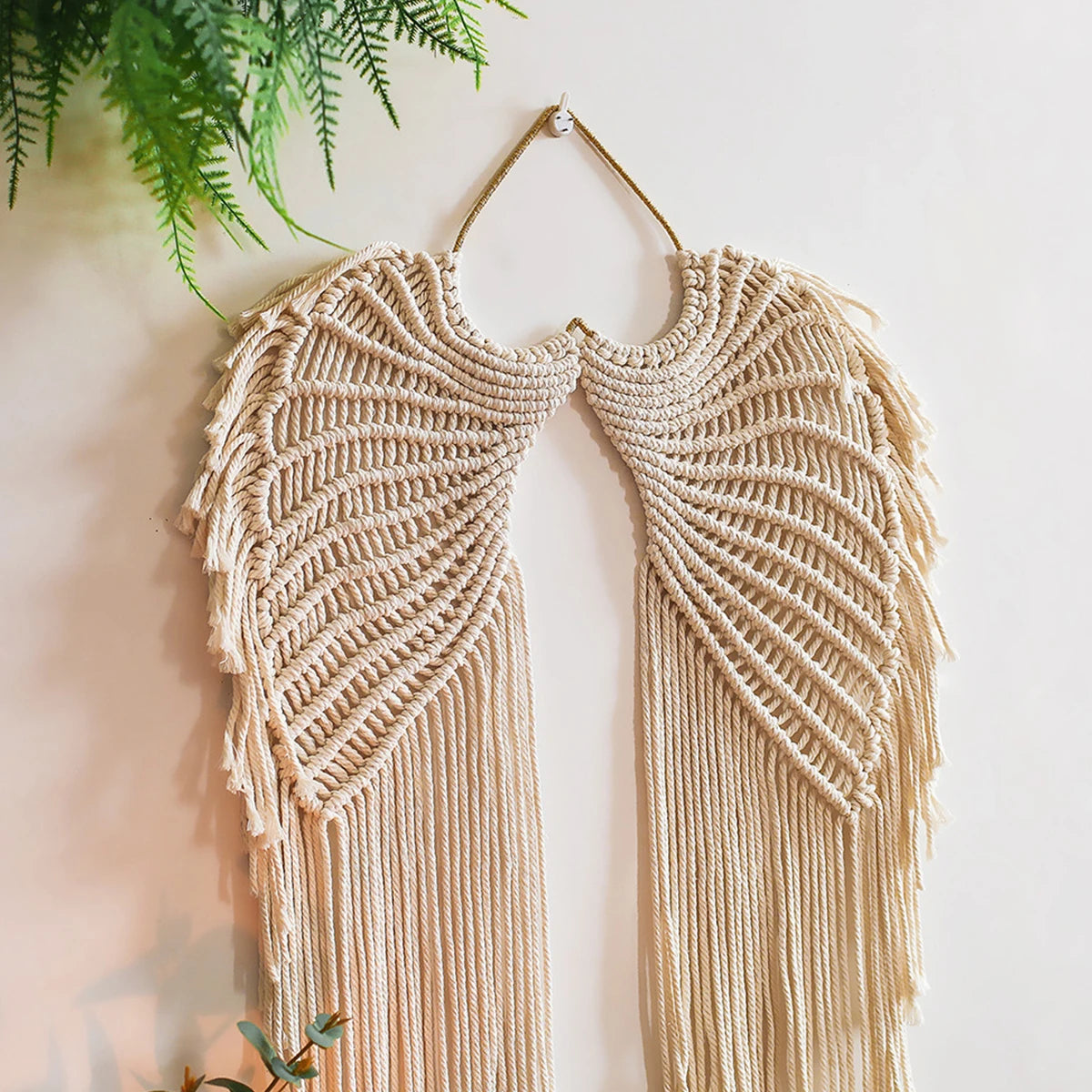 Handwoven angel wing macrame wall hanging in beige fiber