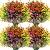 A bouquet of artificial flowers featuring vibrant colors like red, orange, yellow, and pink clustered on green stems.