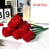 A small bouquet of red silk rose flower building blocks displayed on a white surface.