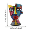 A colorful abstract resin decorative planter pot shaped like a stylized face.