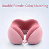 A pink U-shaped memory foam neck pillow shown in a top-down view.