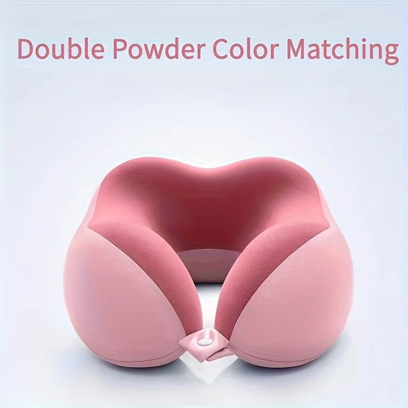 A pink U-shaped memory foam neck pillow shown in a top-down view.