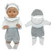 A baby doll outfit set featuring a gray knitted hat, white top, and gray shorts with white socks.