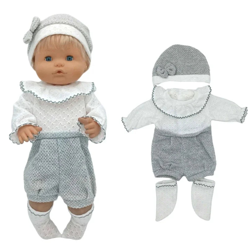 A baby doll outfit set featuring a gray knitted hat, white top, and gray shorts with white socks.